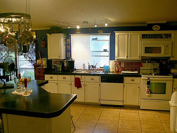 View of Spacious Open Kitchen from the Formal Dining Room - Showing the Large Island & wall of Cabin