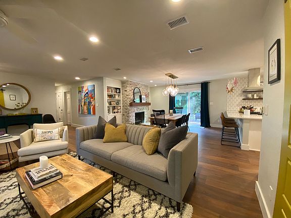 open floor plan living spaces and hallway to three bedrooms on the left.