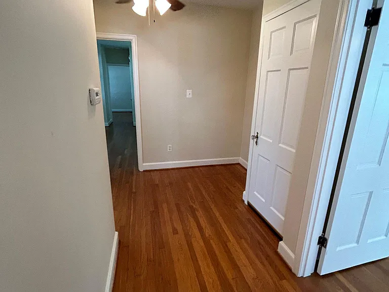 Hallway leading to MB on right, basement, bath, DR