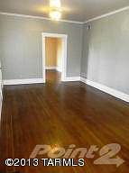 living room with view of entry to den
