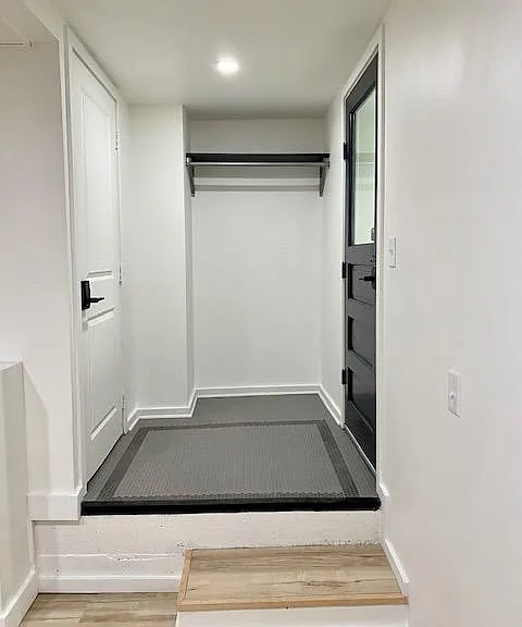 Tiled entry with coat rack.