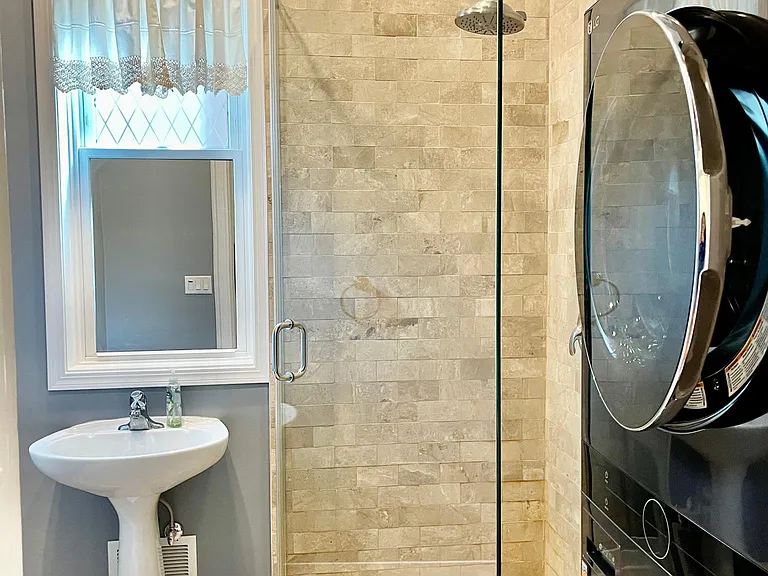 Bath, includes sink, shower, and brand new LG laundry.