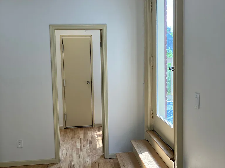 Utility door for hot water heater and heating system in the walk in closet