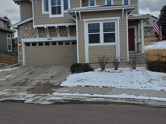 Front Exterior of house in winter. Ample garage, driveway, and street parking nearby.