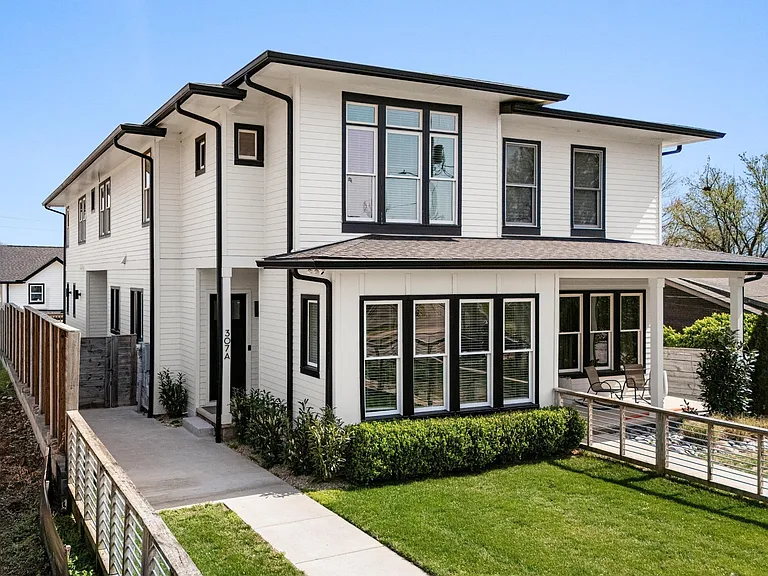 Modern East Nashville home with welcoming front porch and contemporary black-and-white exterior.