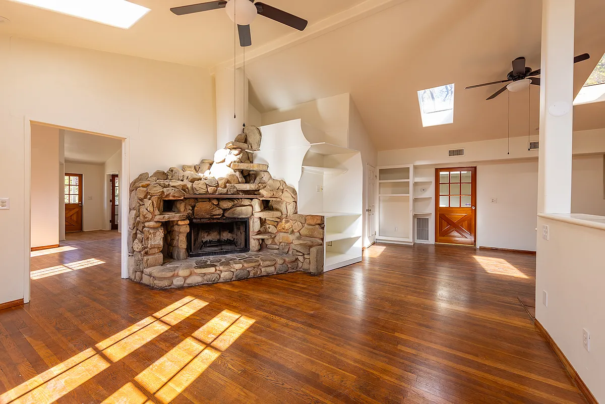 Living Space with Wood Floors and Rock Fireplace - 402 N Montgomery St