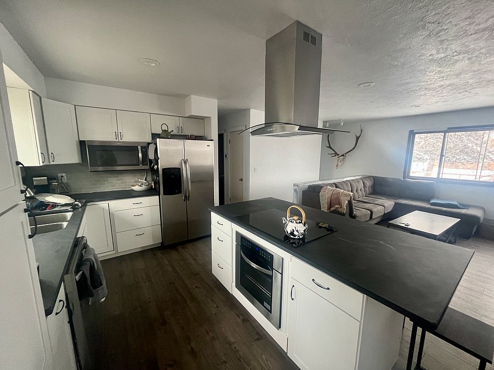 Kitchen island with granite countertops, stainless steel appliances, and an induction cooktop.