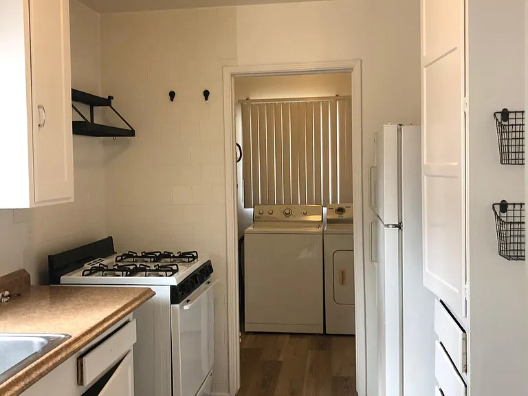Kitchen and laundry room. Front door to the left of laundry room