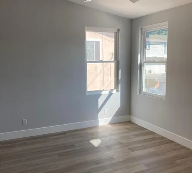 Bedroom has a ceiling fan and slanted ceiling, which opens up the room.
