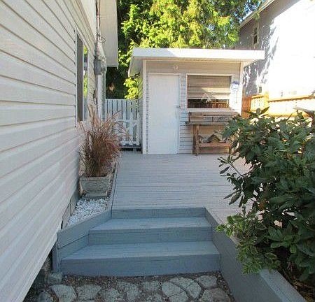 Low maintenance yard with pleasing landscape and large side deck for relaxing.