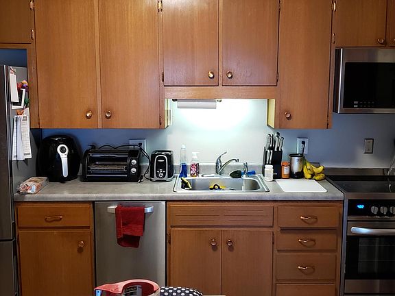 Recent contemporary appliances and real wood cabinets.