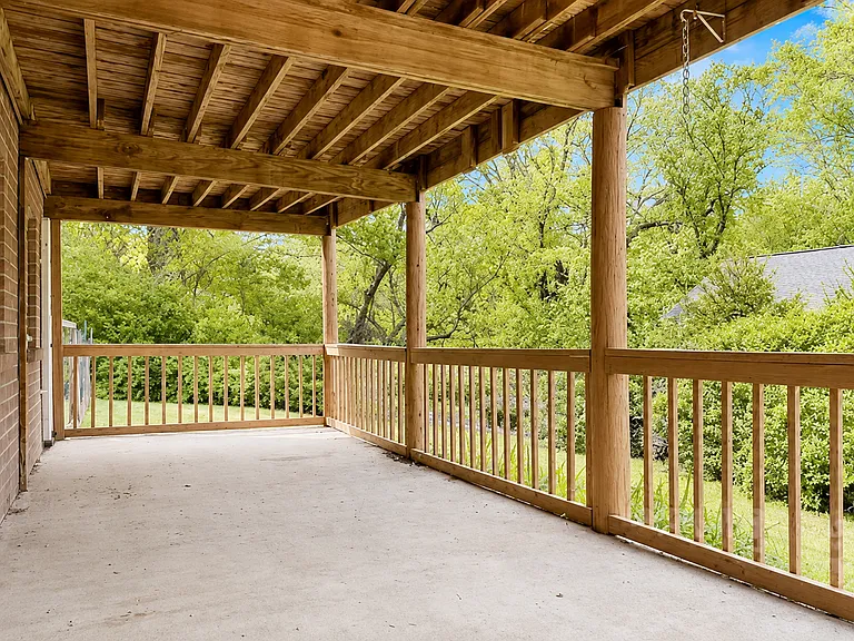 Covered porch with plenty of backyard greenery to enjoy