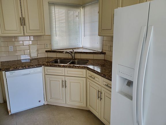 Bright kitchen - granite countertops, side by side refrigerator, new faucet, new garbage disposal