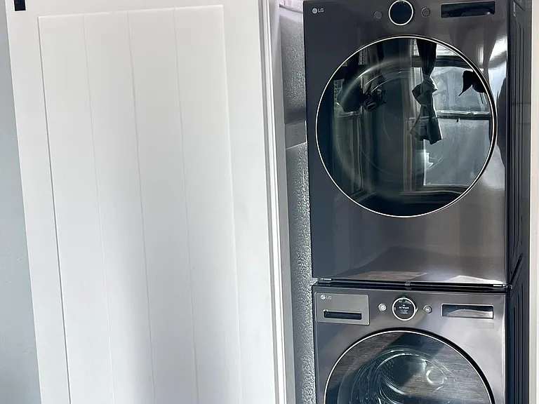 New LG stackable washer & dryer located in the bedroom closet