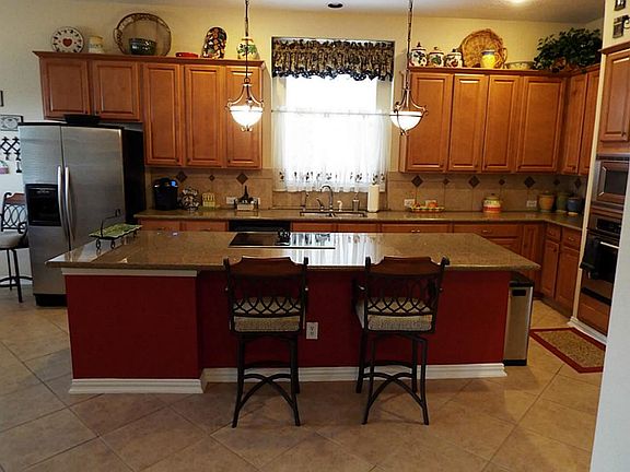 The kitchen is graciously appointed with 42 inch maple cabinets, granite countertops, stainless stee