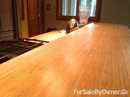 Bamboo 'Bar' Countertops
						:
						An expansive 'cocoa' bamboo 'bar' surrounds the kitchen.