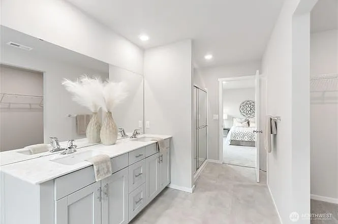 Master bathroom with walk-in closet and walk-in shower.