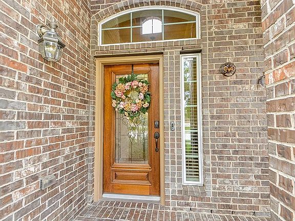 Beveled glass mahogany door greets your guests.