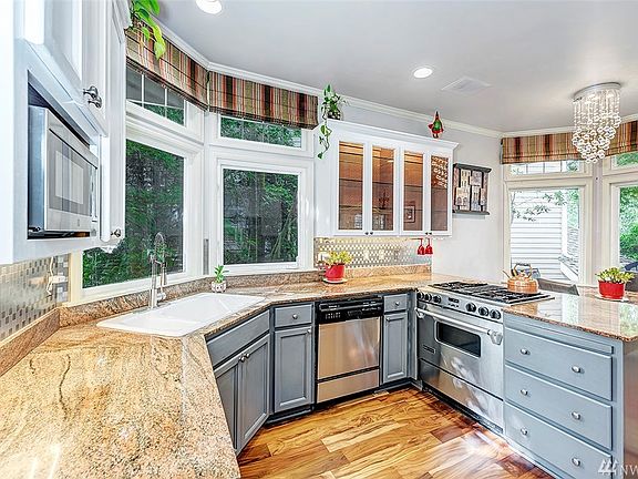 Alternate View Of The Renovated Kitchen. Large Windows + Custom Blinds & Curtains Throughout The Home.