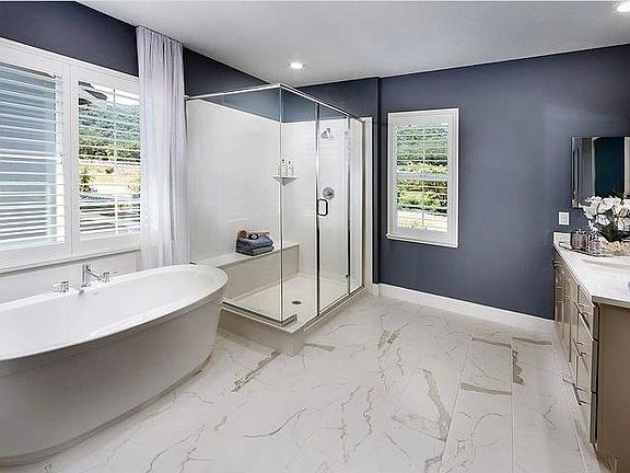 Master Bathroom with stand alone tub, two sinks, and large walk in closet.