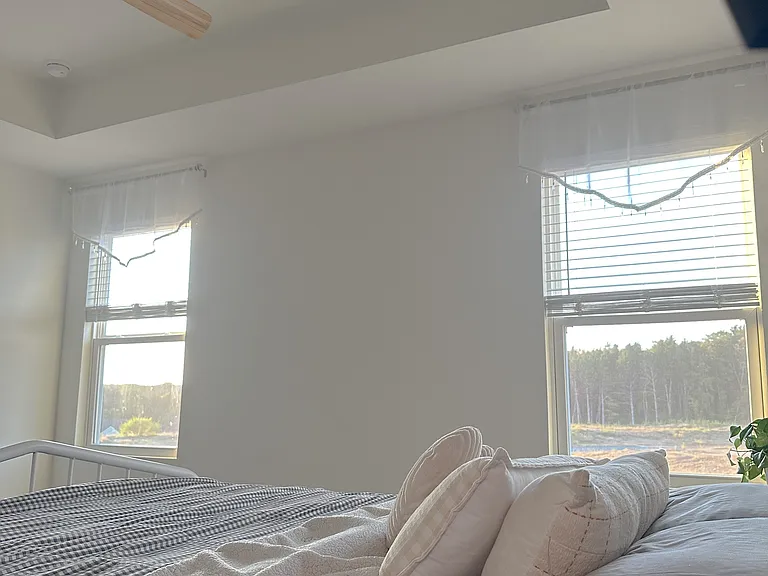 Master bedroom offers serene wooded and sunset views right from the comfort of your bed - a perfect setting for relaxation and peaceful evenings!