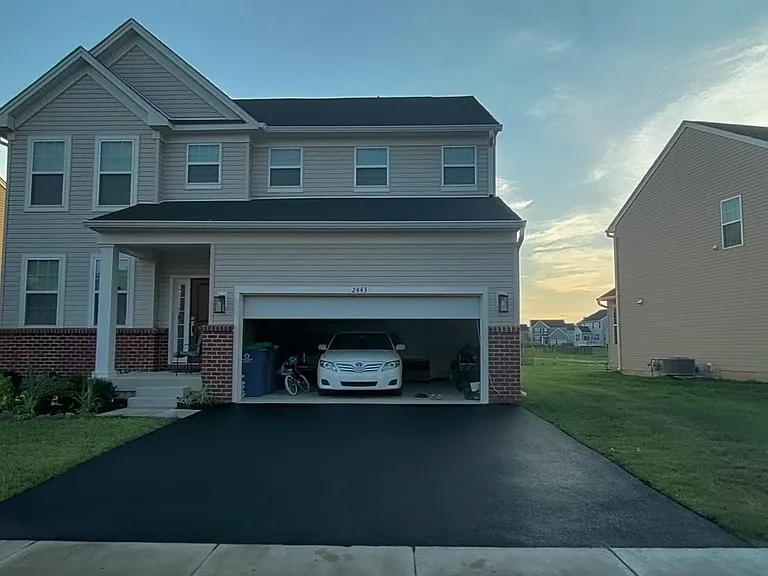 Two car garage + 4 cars parking on black top and street.