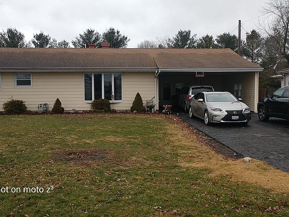 Front of house with carport