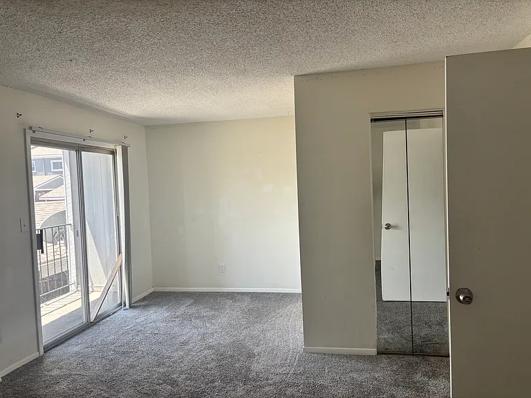 Primary Bedroom featuring en suite full bath, walk in closet and balcony