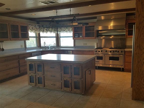 Gourmet kitchen with Corian countertops Viking stove and Jenn Air refrigerator.