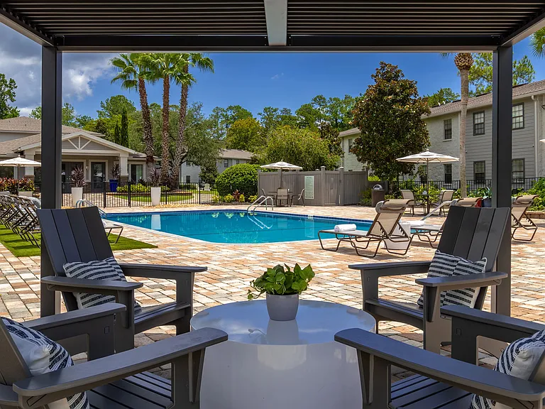 Engage in delightful conversations out of the sun at our poolside pergola.