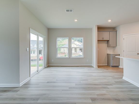 Gather the family around the dining table, at the heart of the open-concept living area.