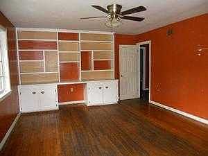 Spacious living room with hardwood floors and buil