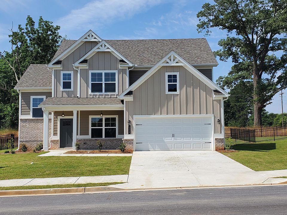 Exterior shot of the two story homes with private driveways and attached garages.