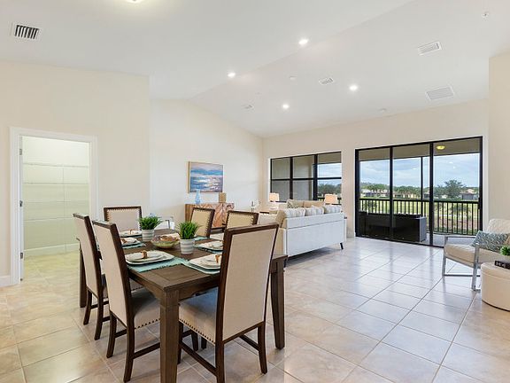 Open layout with connected gathering room, dining spaces, and kitchen