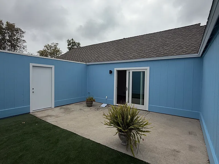 Courtyard facing garage and residence