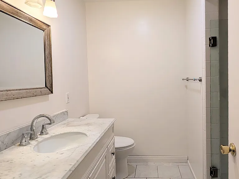 3/4 Bath with large vanity and marble counter top