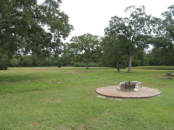 Fire pit area with stock tank in background