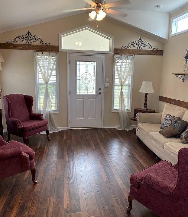 Living room is spacious and bright with laminate flooring and crown molding. Furniture not included. Property not furnished.