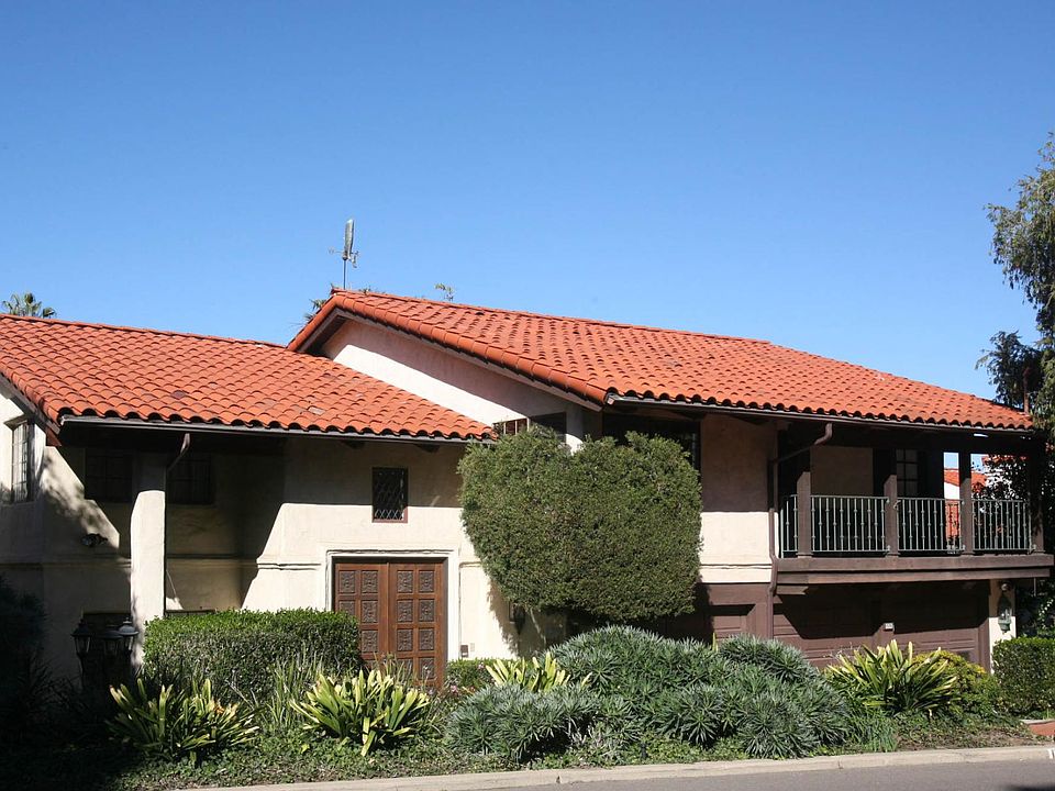 Hand Carved Front Doors, Wrought Iron Balcony and a 3-car garage!!