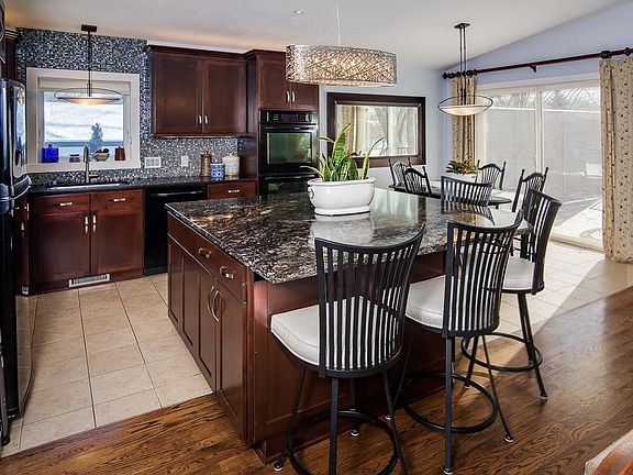 Updated kitchen has sparkling granite center island, perfect for gathering! Main level is so open and bright!