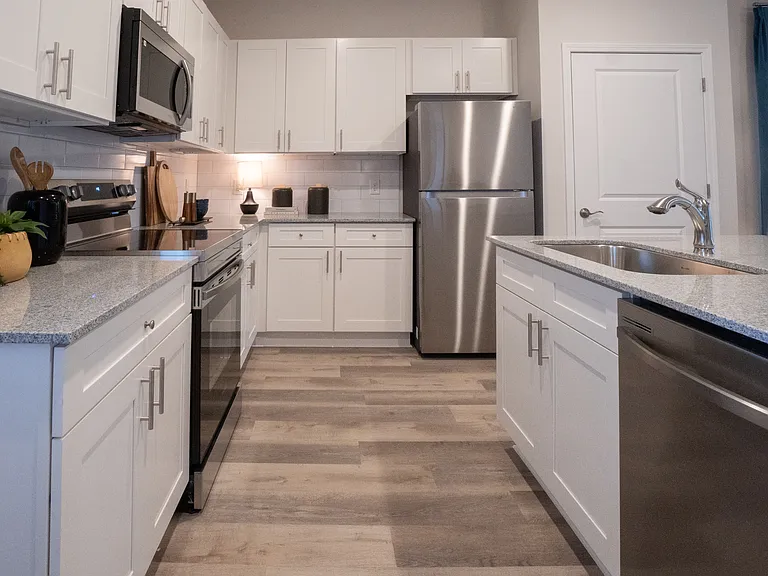 Chef-inspired kitchen with granite countertops and stainless steel appliances.