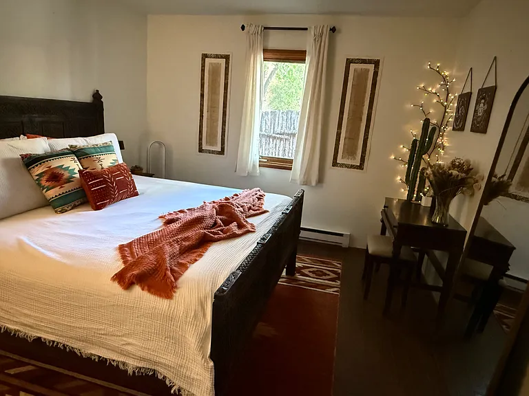 King-size bed with high-quality linens in a quiet, comfortable setting.