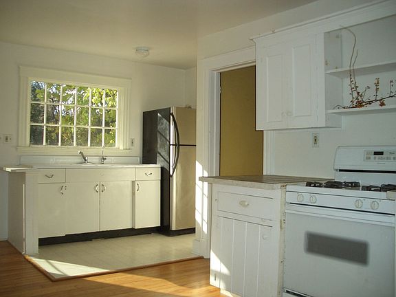 bright open kitchen with new appliances over look the backyard.