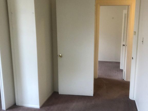 Front bedroom looking into hallway. Back bedroom across hallway