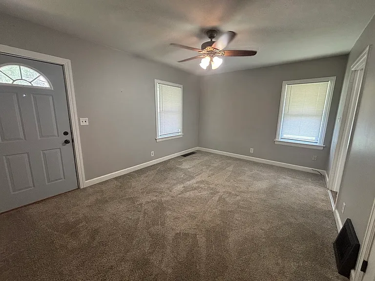 The view of the living room from the hallway by the bedrooms and bathroom