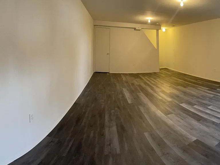 finished basement with laminated floors.