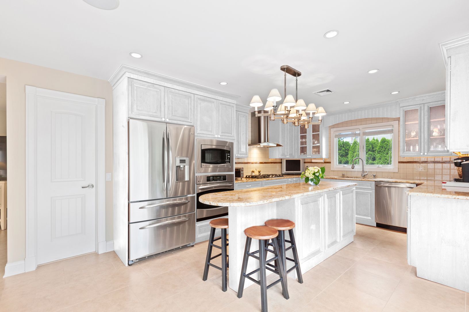  here's what the kitchen would look if the cabinets were refinished in white for a more beachy look 