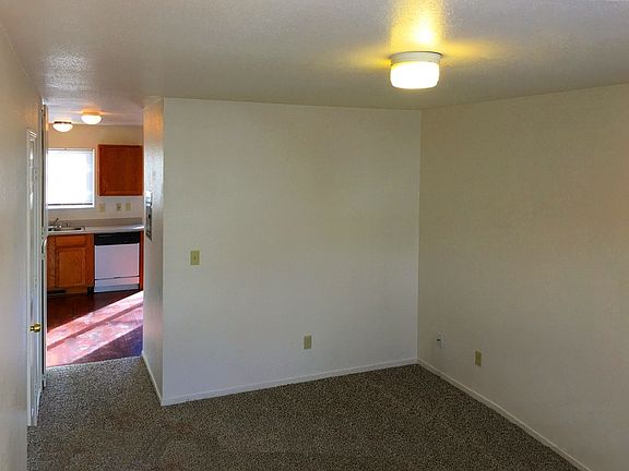 Living room with half-bath and access to kitchen.
