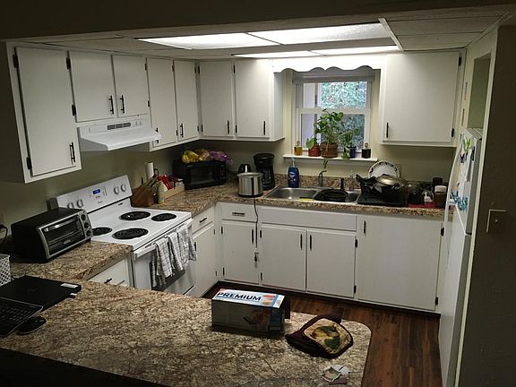 Spacious kitchen with plenty of cabinet storage space, refrigerator and oven range included in unit