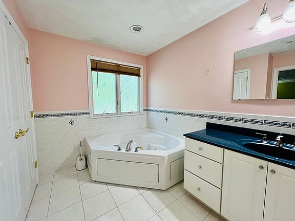Huge master bath with jacuzzi tub and shower stand. Large linen closet.